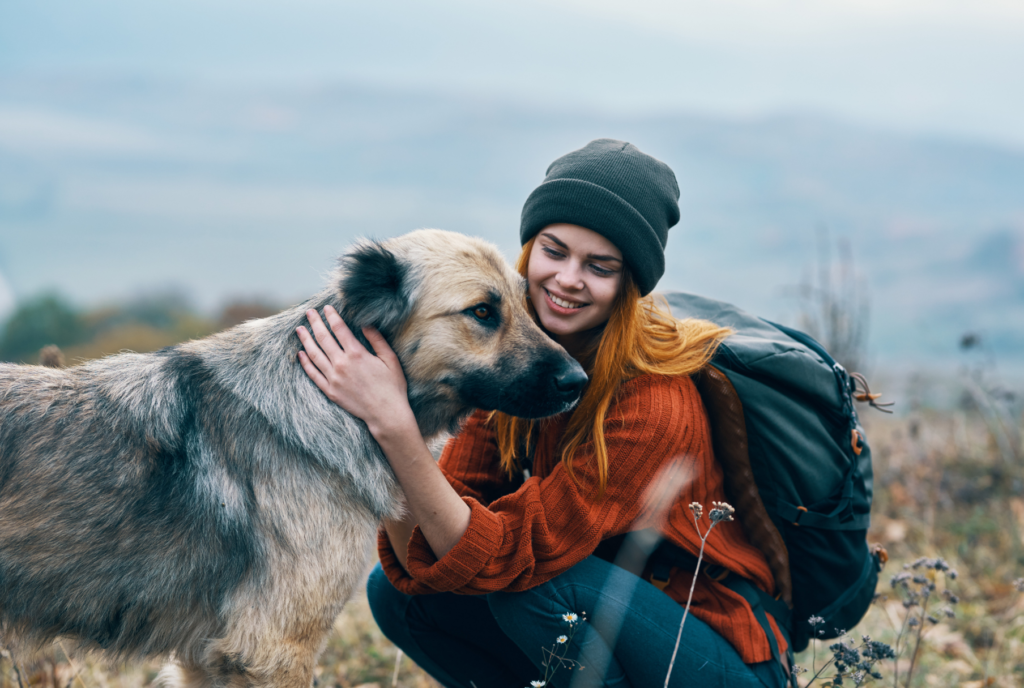 Woman hugging her dog in nature